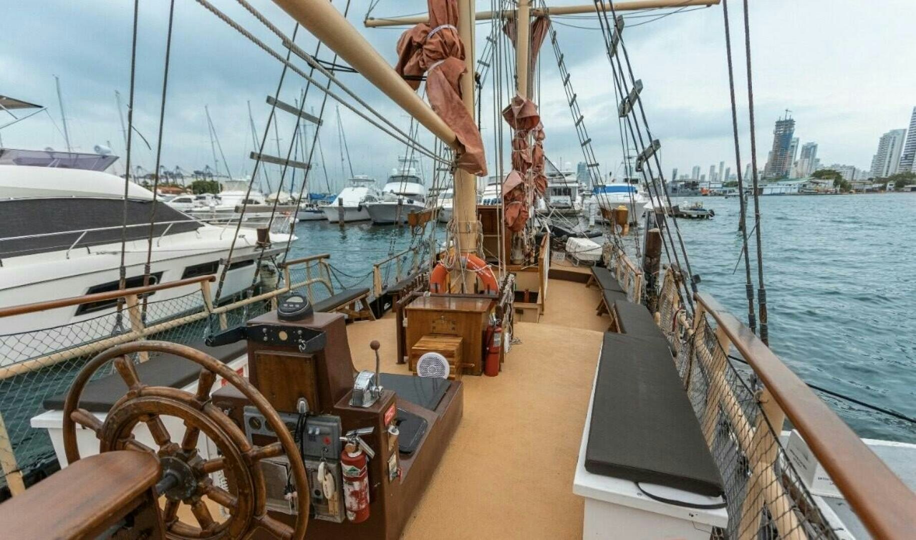 a boat with a large wheel aboard LA FANTASTICA Yacht for Sale