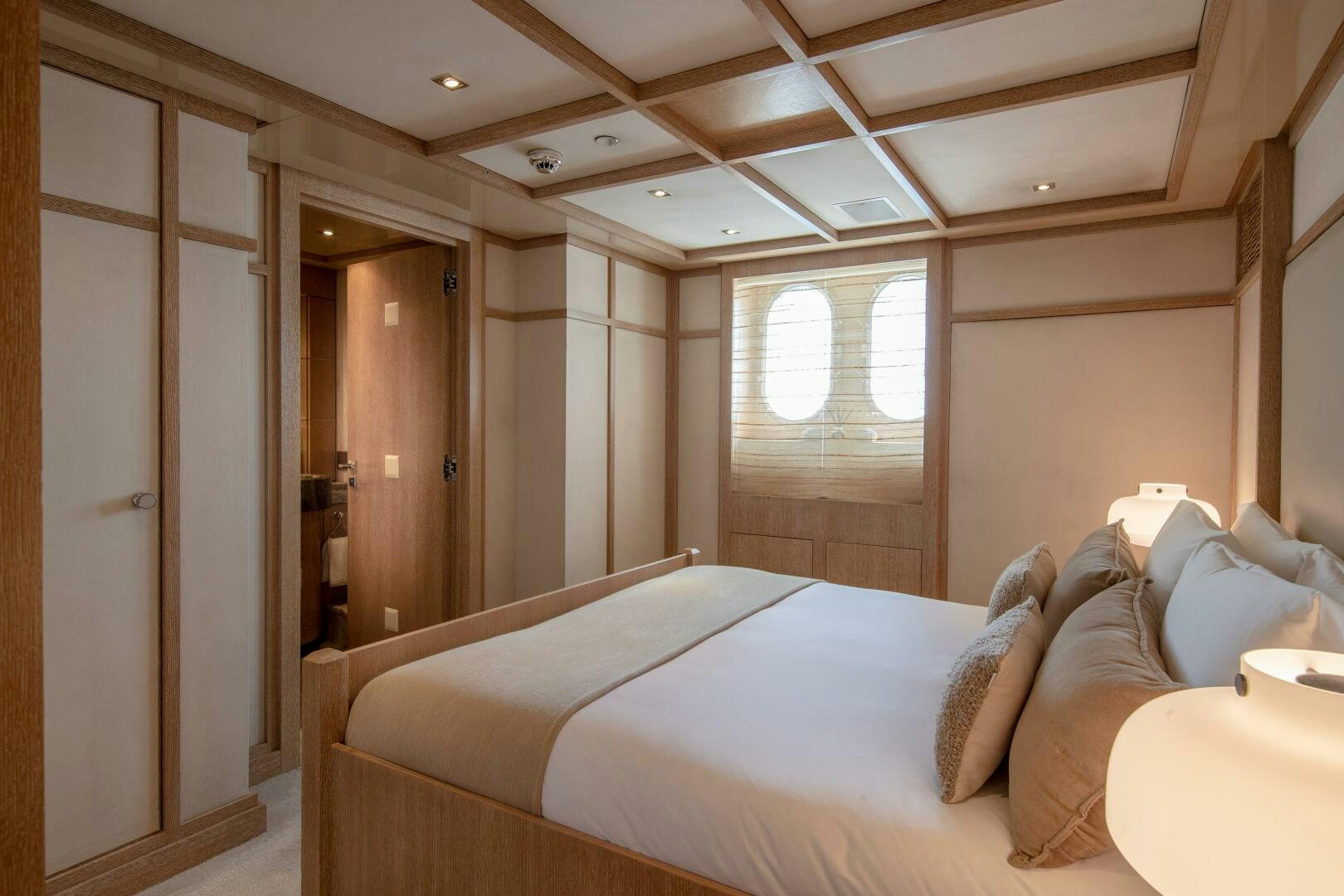 a room with a bed and a mirror aboard FRIENDSHIP Yacht for Sale