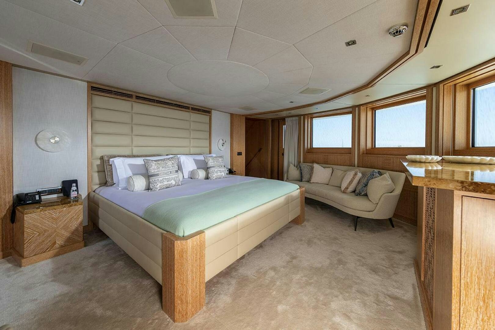 a bedroom with a bed and a couch aboard FRIENDSHIP Yacht for Sale