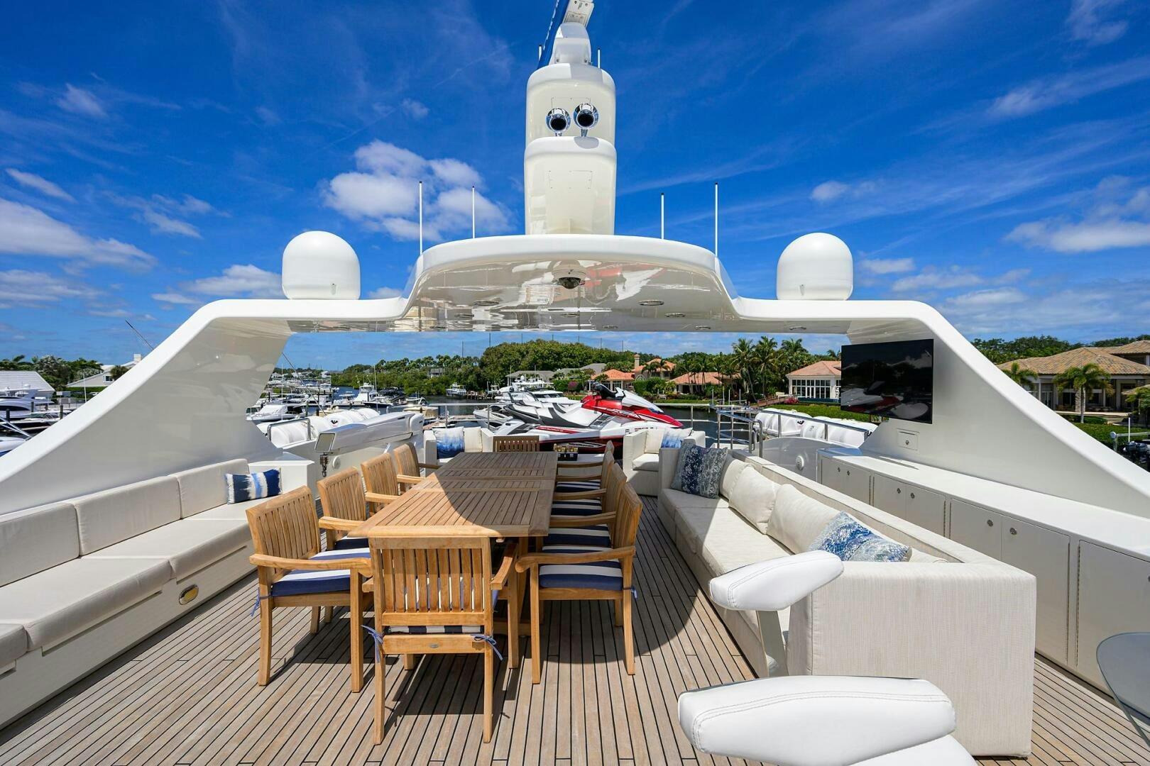 a deck with chairs and a table on it aboard KIMBERLIE Yacht for Sale