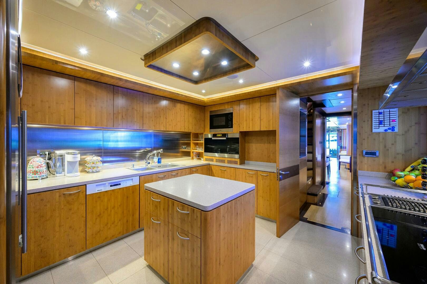 a kitchen with wooden cabinets aboard KIMBERLIE Yacht for Sale