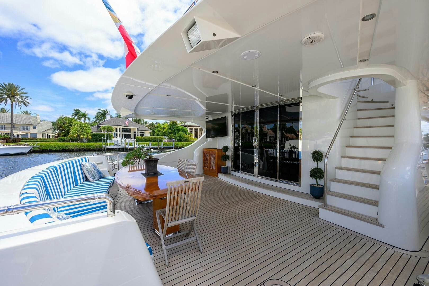 a deck with a pool and a deck with chairs and a table and a pool and trees and aboard KIMBERLIE Yacht for Sale