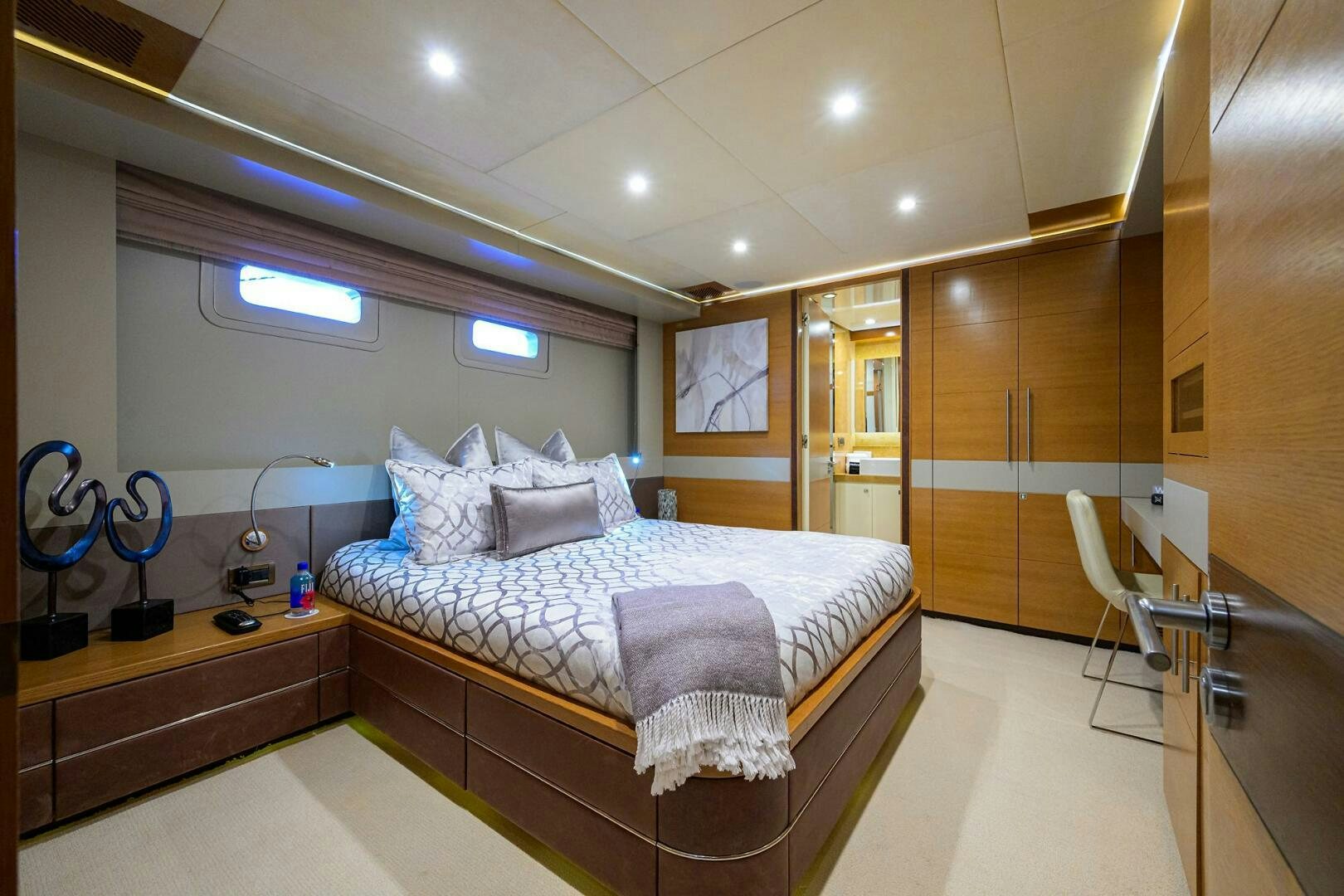 a bedroom with a bed and a desk aboard KIMBERLIE Yacht for Sale