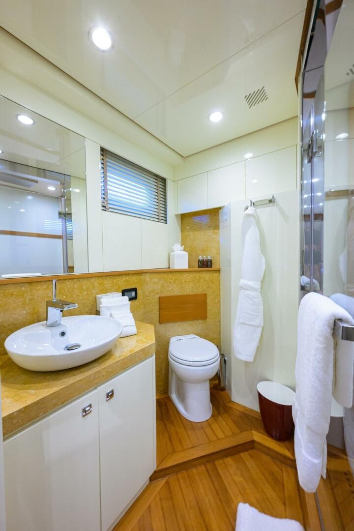 a bathroom with a sink toilet and a mirror aboard KIMBERLIE Yacht for Sale