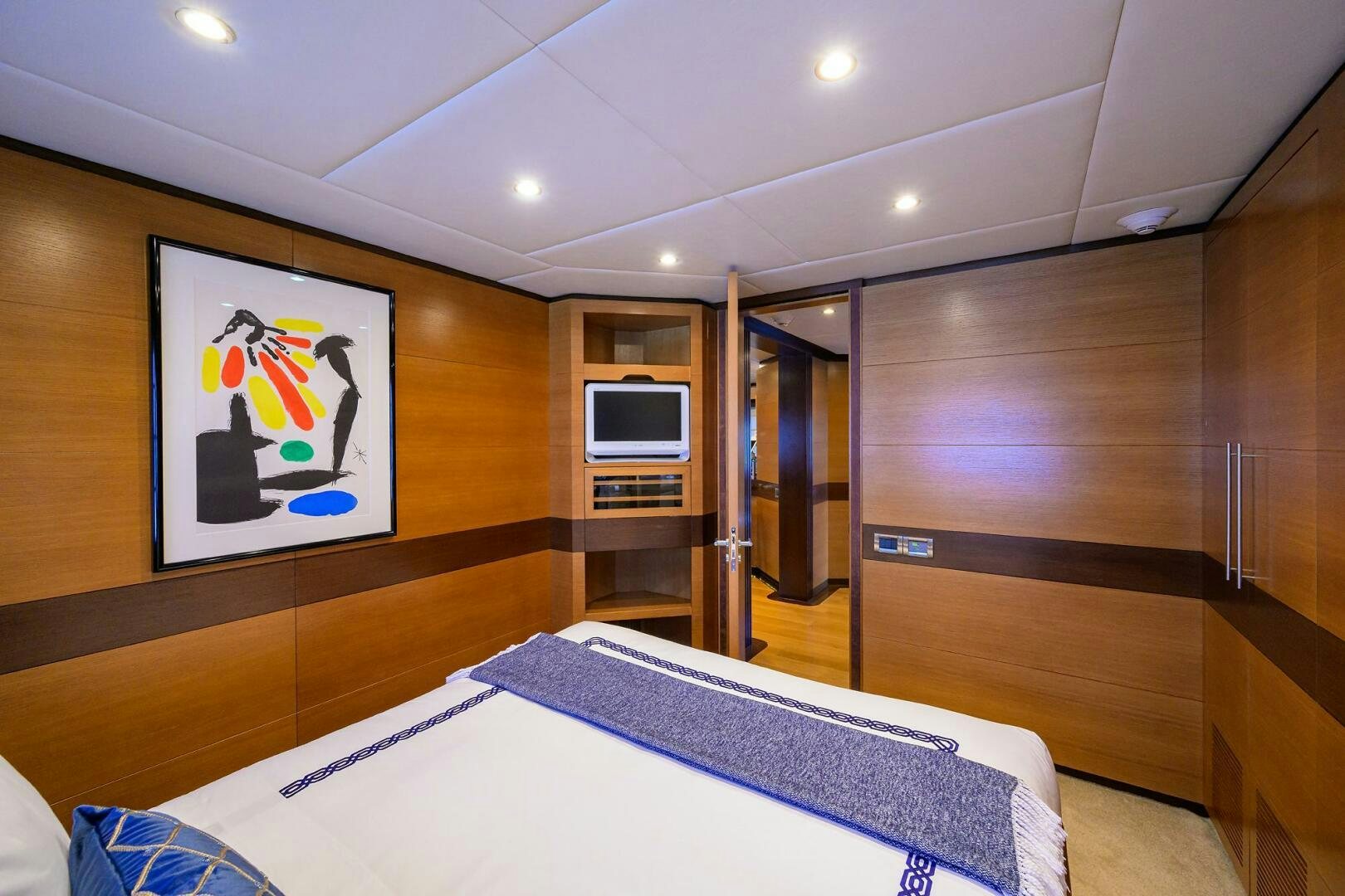 a bedroom with a bed and a tv on the wall aboard KIMBERLIE Yacht for Sale