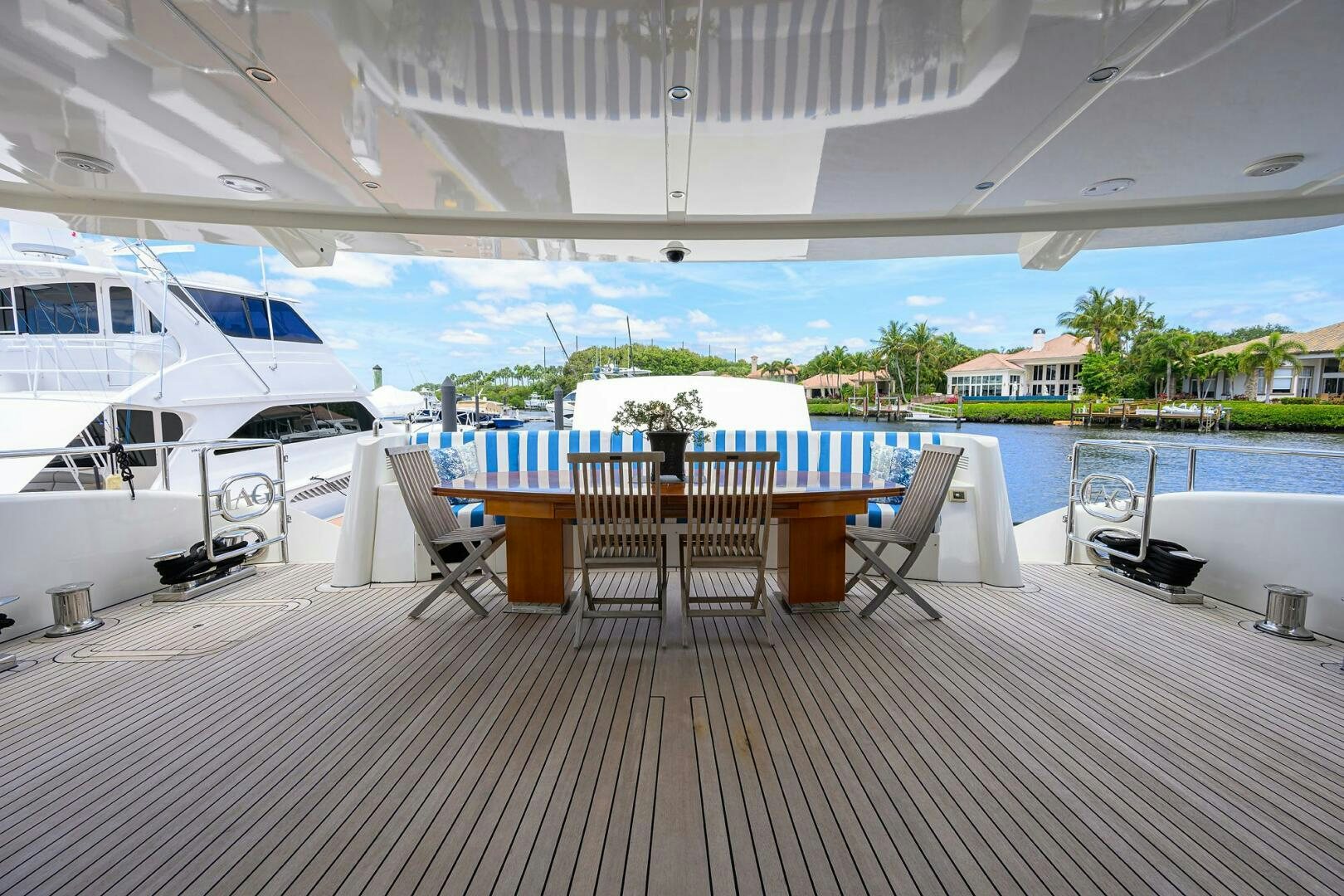 a patio with tables and chairs aboard KIMBERLIE Yacht for Sale
