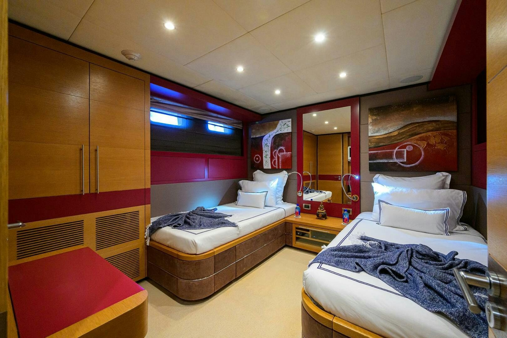 a room with a bed and a mirror aboard KIMBERLIE Yacht for Sale