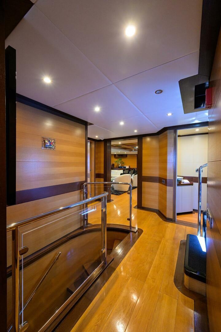 a room with a wood floor and a large mirror aboard KIMBERLIE Yacht for Sale