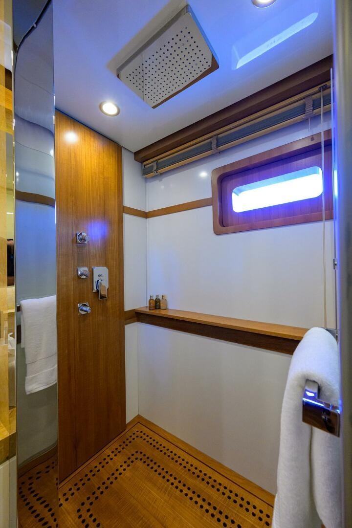 a bathroom with a door and a window aboard KIMBERLIE Yacht for Sale