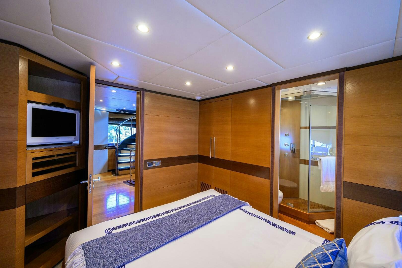 a bedroom with a bed and a tv aboard KIMBERLIE Yacht for Sale