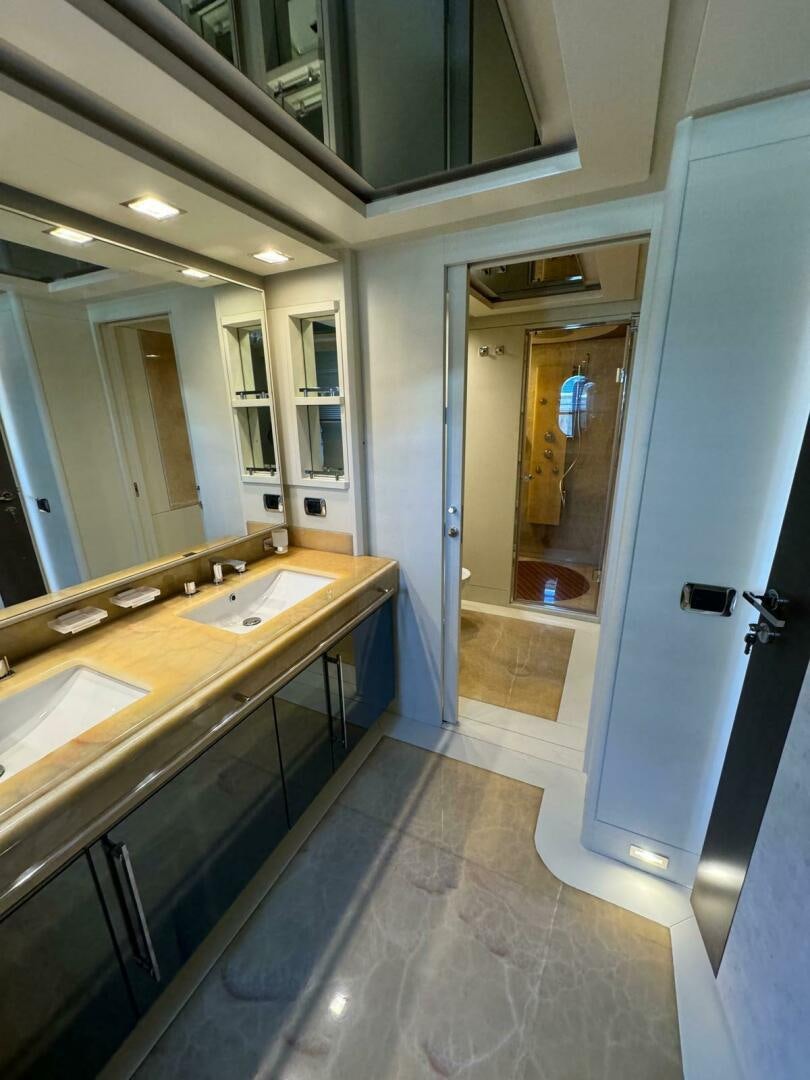 a bathroom with a countertop sink and a mirror aboard SERENDIPITY Yacht for Sale