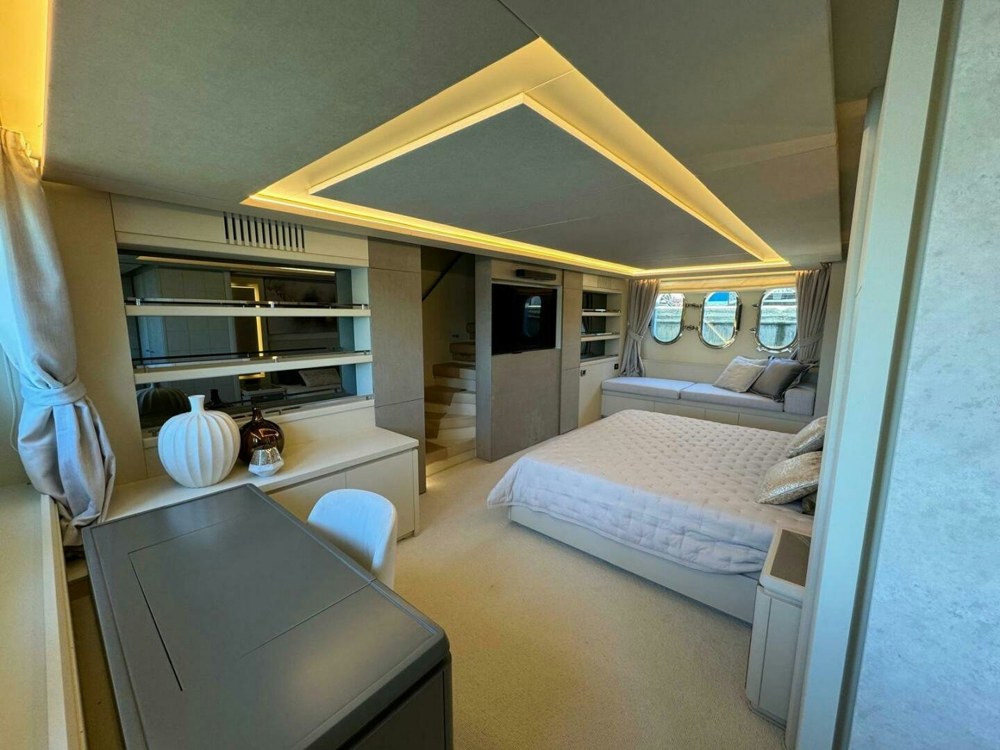 a bedroom with a bed and a desk aboard SERENDIPITY Yacht for Sale