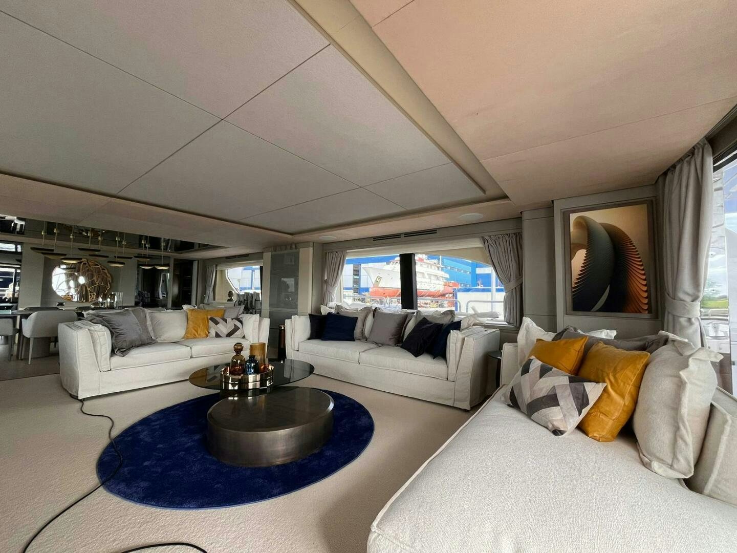 a living room with a large blue rug aboard SERENDIPITY Yacht for Sale