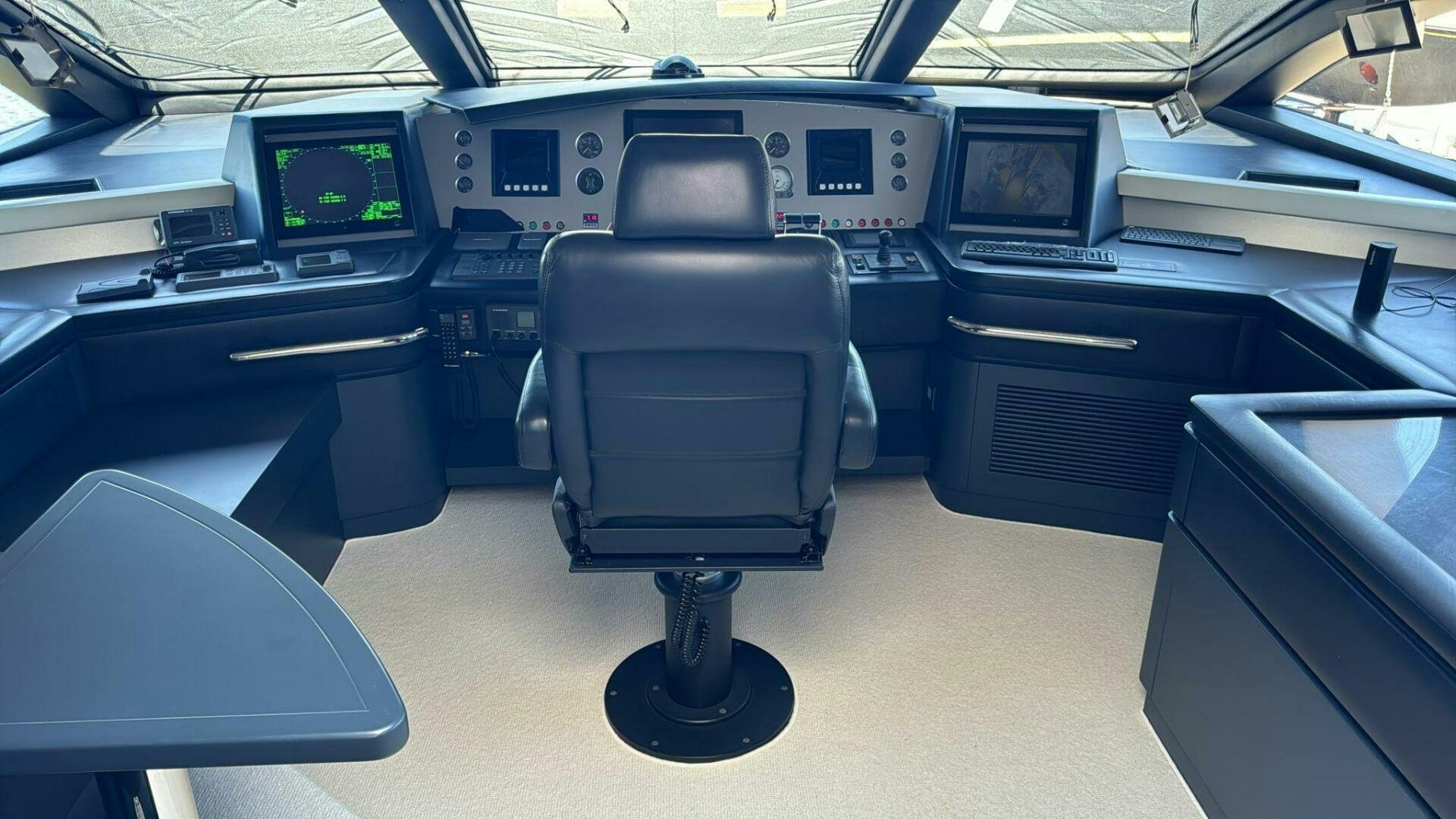 a black and grey chair in a room with a black table and chairs aboard SERENDIPITY Yacht for Sale