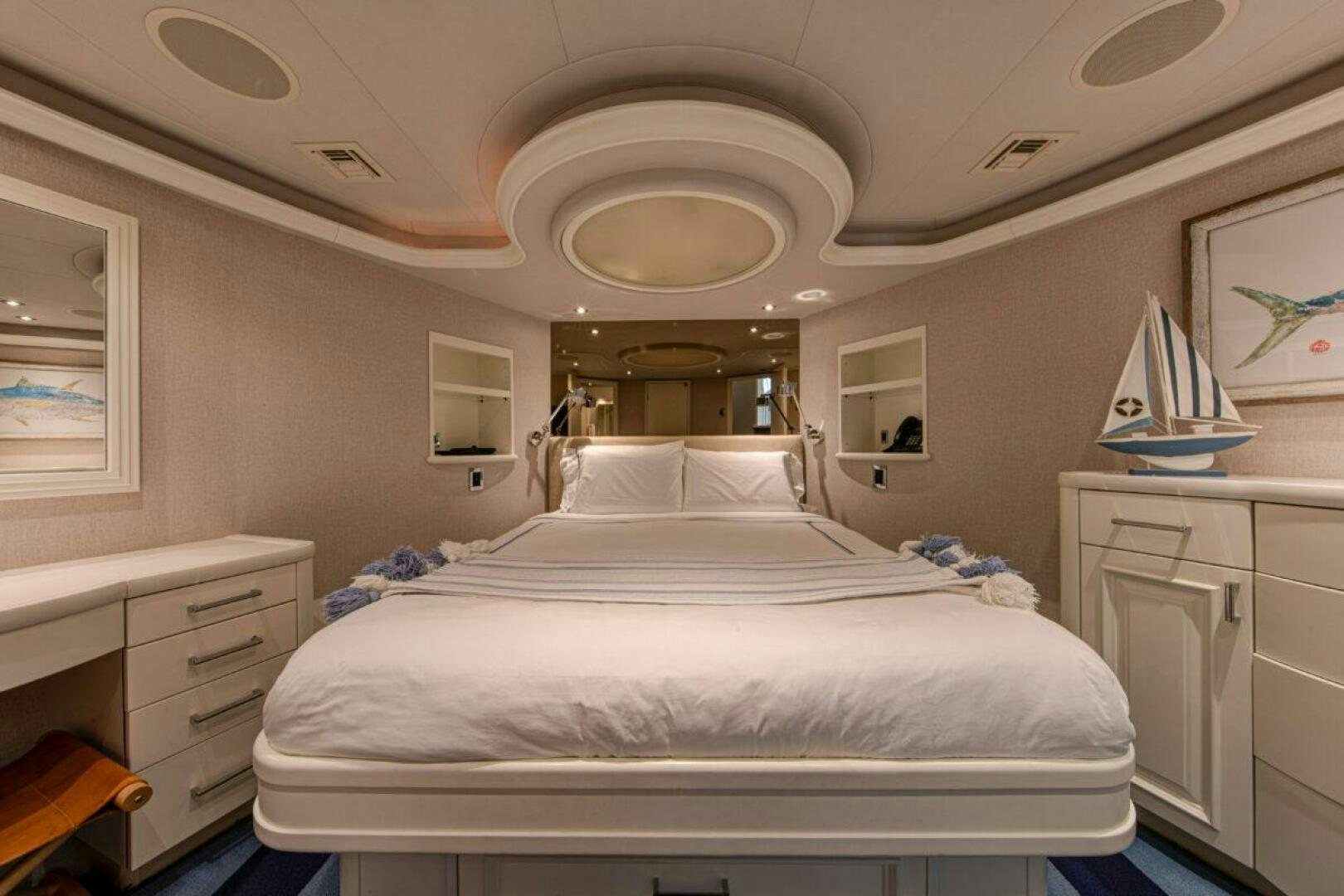 a bedroom with a bed and a lamp on the ceiling aboard BOXER Yacht for Sale