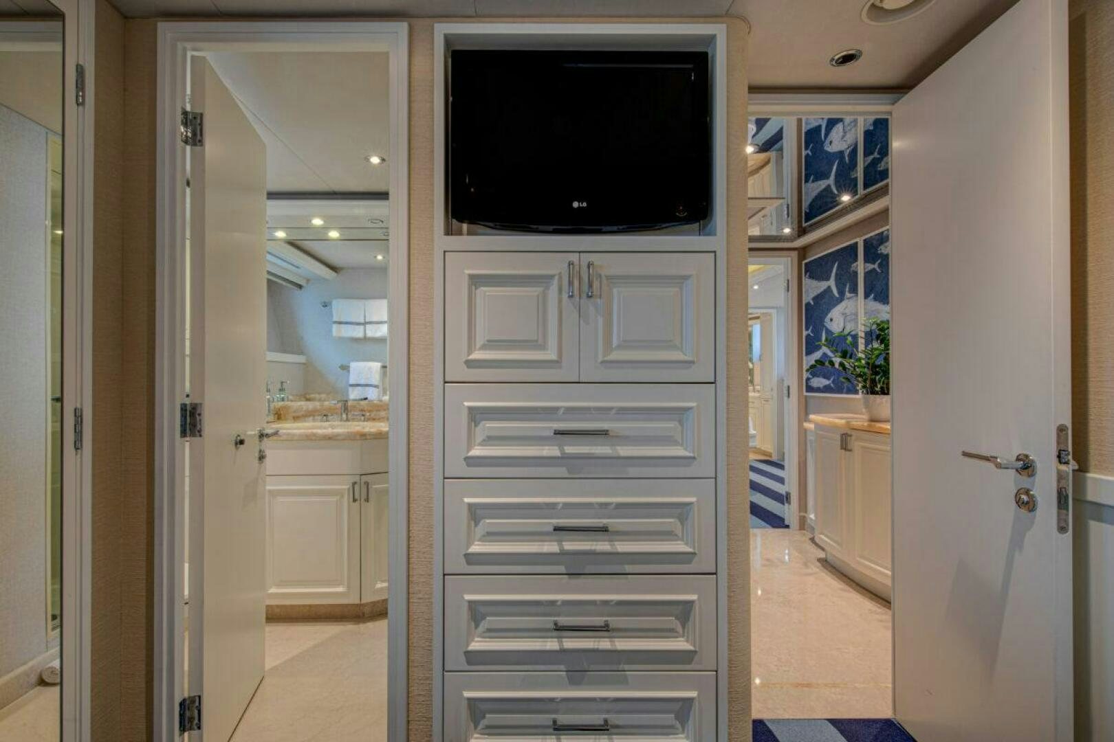 a white bathroom with a flat screen television on the wall aboard BOXER Yacht for Sale