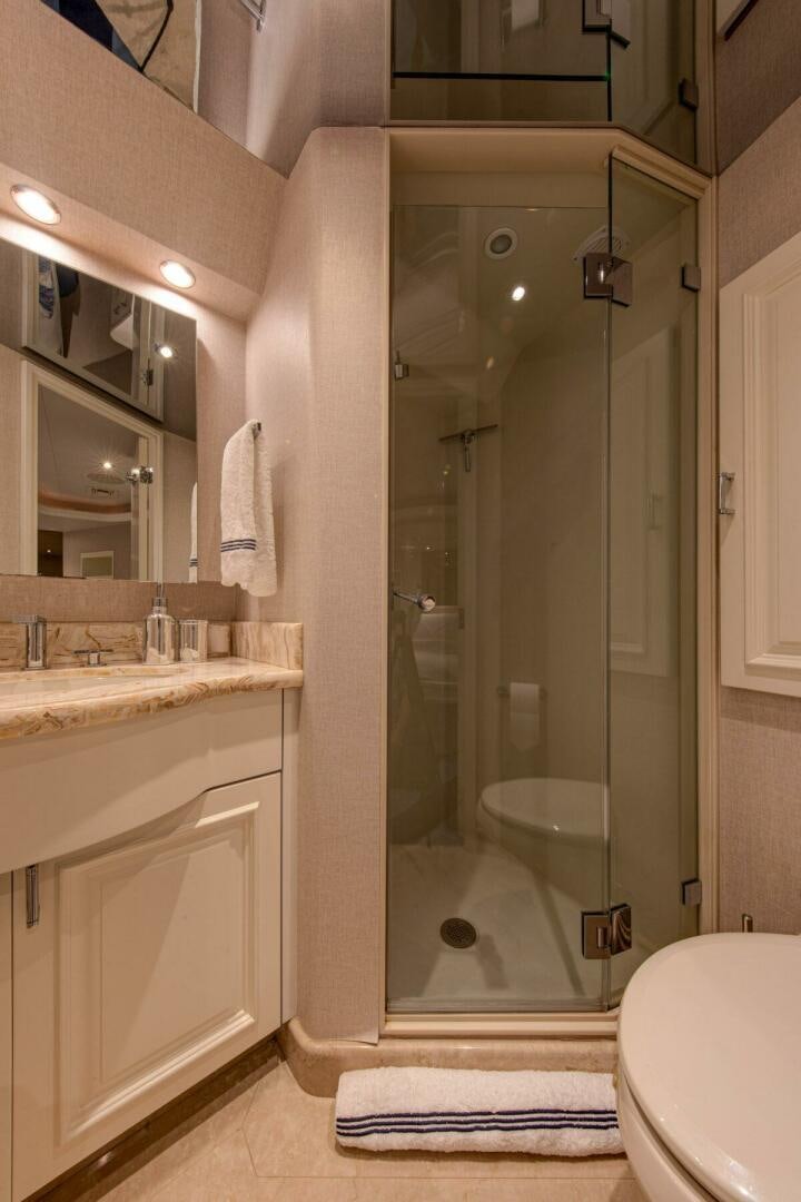 a bathroom with a glass shower aboard BOXER Yacht for Sale