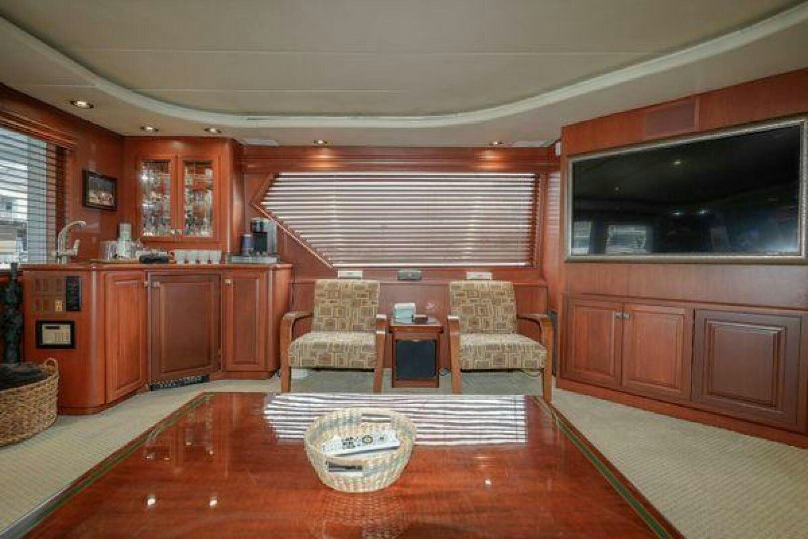 a living room with a kitchen and dining area aboard POLE POSITION Yacht for Sale