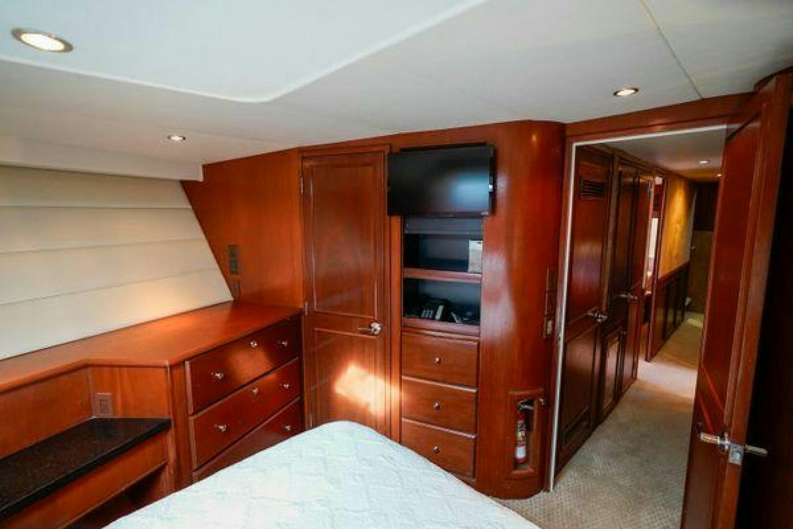 a bedroom with a bed and a closet aboard POLE POSITION Yacht for Sale