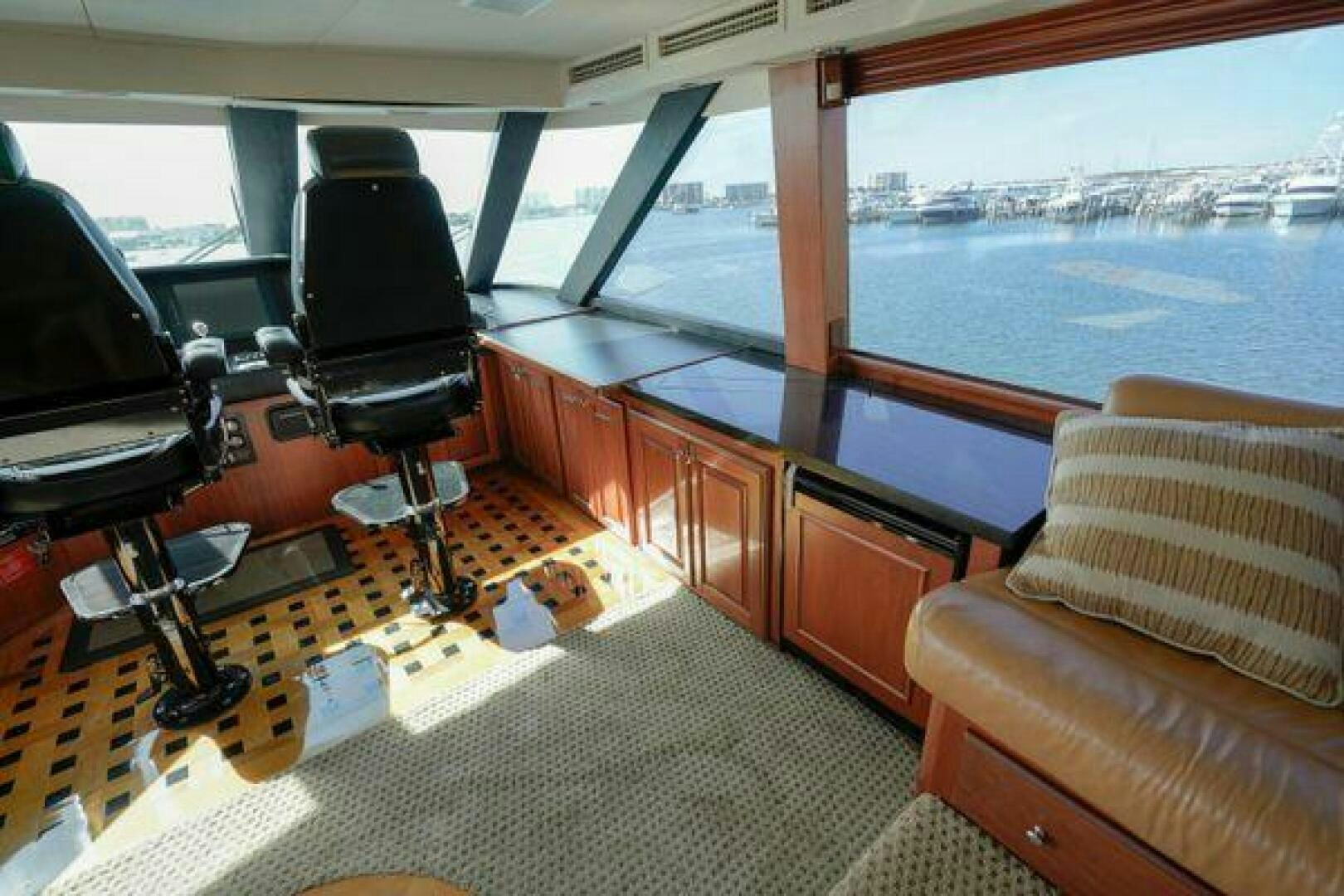 a room with a chair and a table and a window aboard POLE POSITION Yacht for Sale