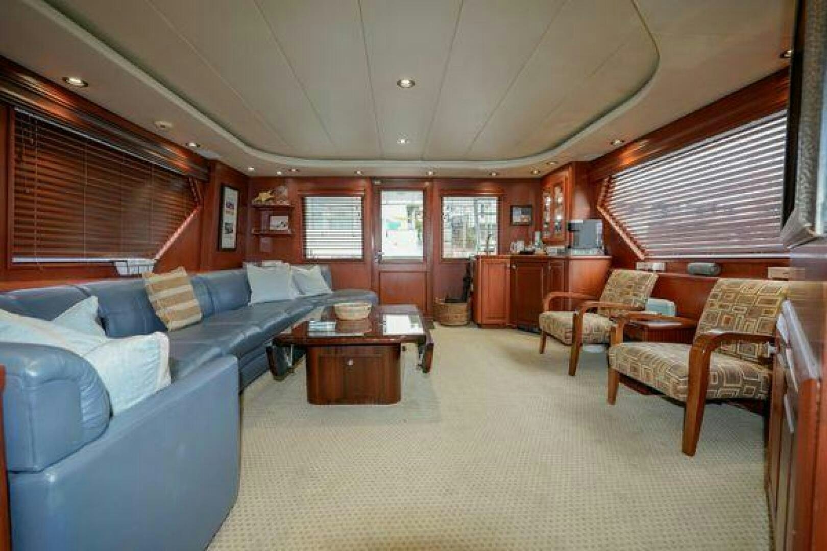 a large living room with a couch and a table aboard POLE POSITION Yacht for Sale