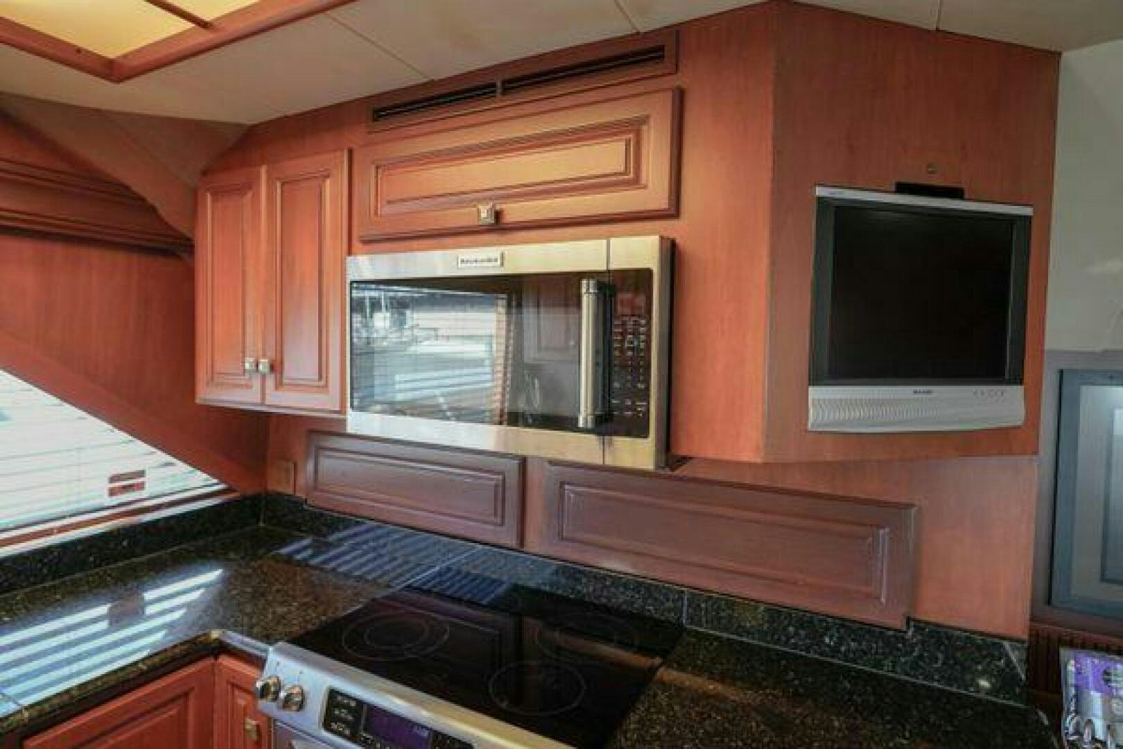 a kitchen with wooden cabinets aboard POLE POSITION Yacht for Sale
