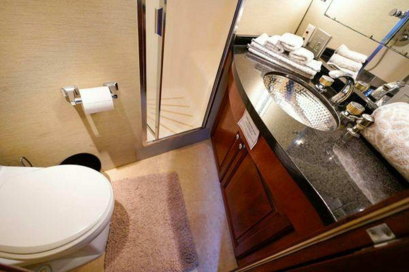 a bathroom with a sink and a toilet aboard POLE POSITION Yacht for Sale