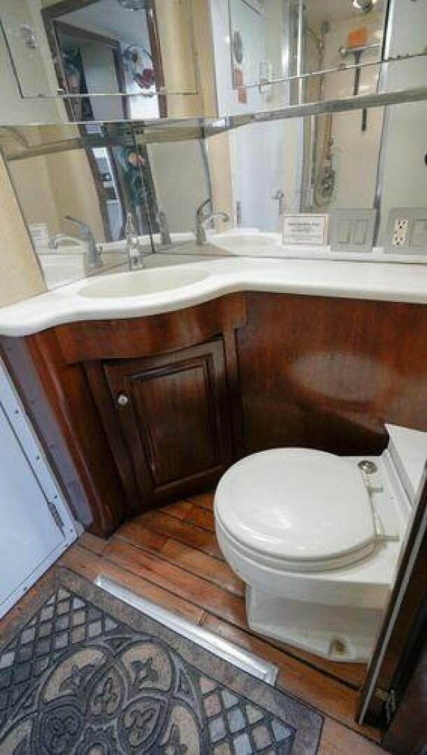 a bathroom with a toilet and sink aboard POLE POSITION Yacht for Sale