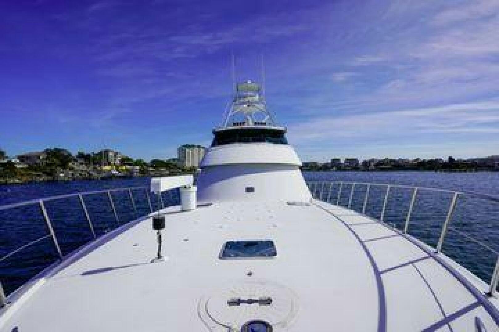 a white boat on a dock aboard POLE POSITION Yacht for Sale