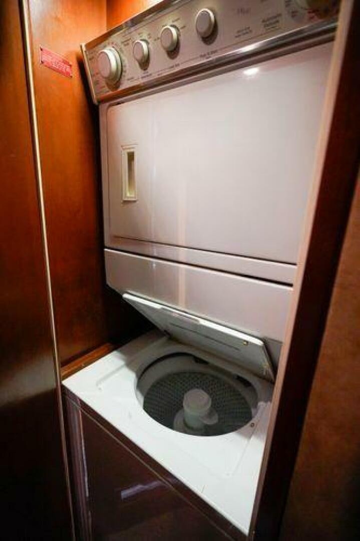 a washer and dryer in a room aboard POLE POSITION Yacht for Sale
