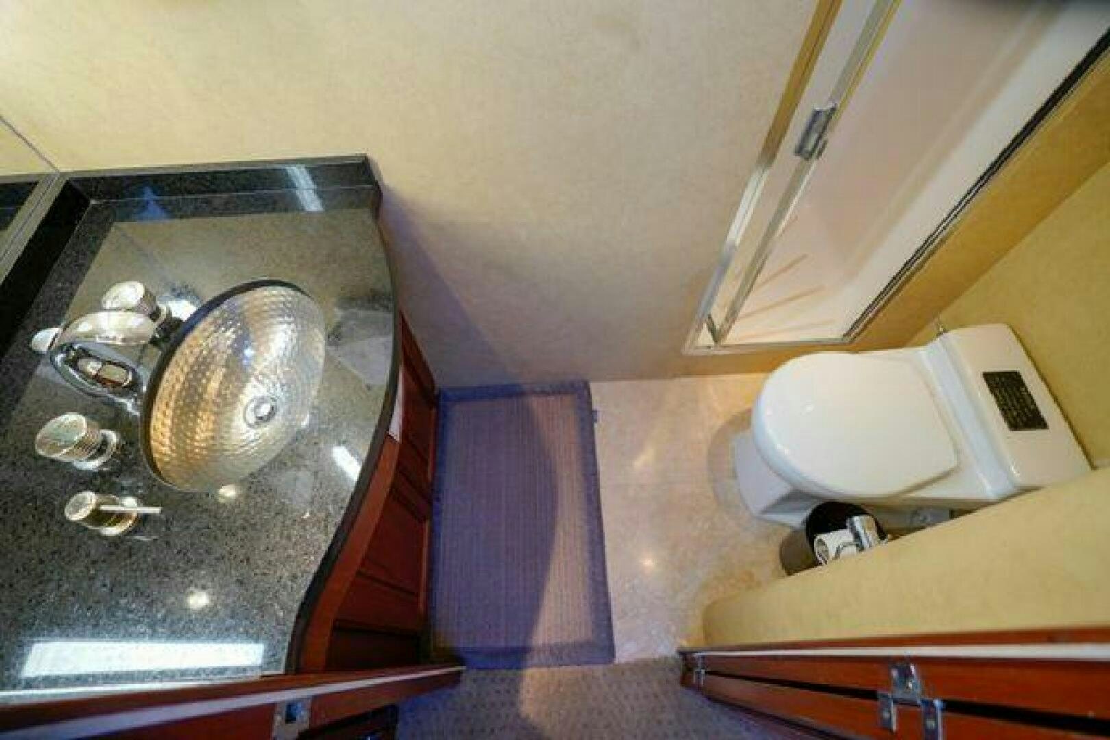 a sink and a mirror in a bathroom aboard POLE POSITION Yacht for Sale