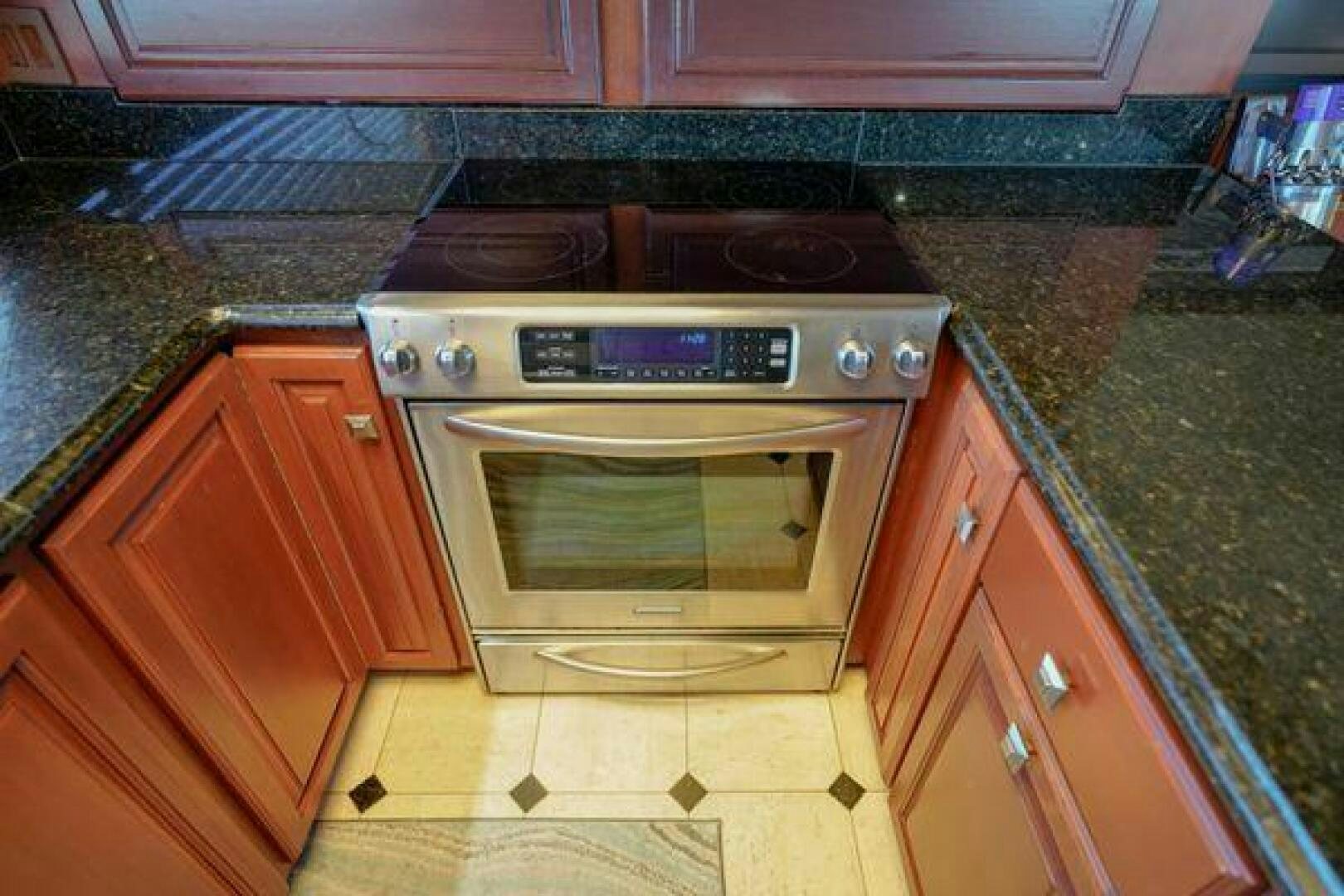 a kitchen with a stove and oven aboard POLE POSITION Yacht for Sale