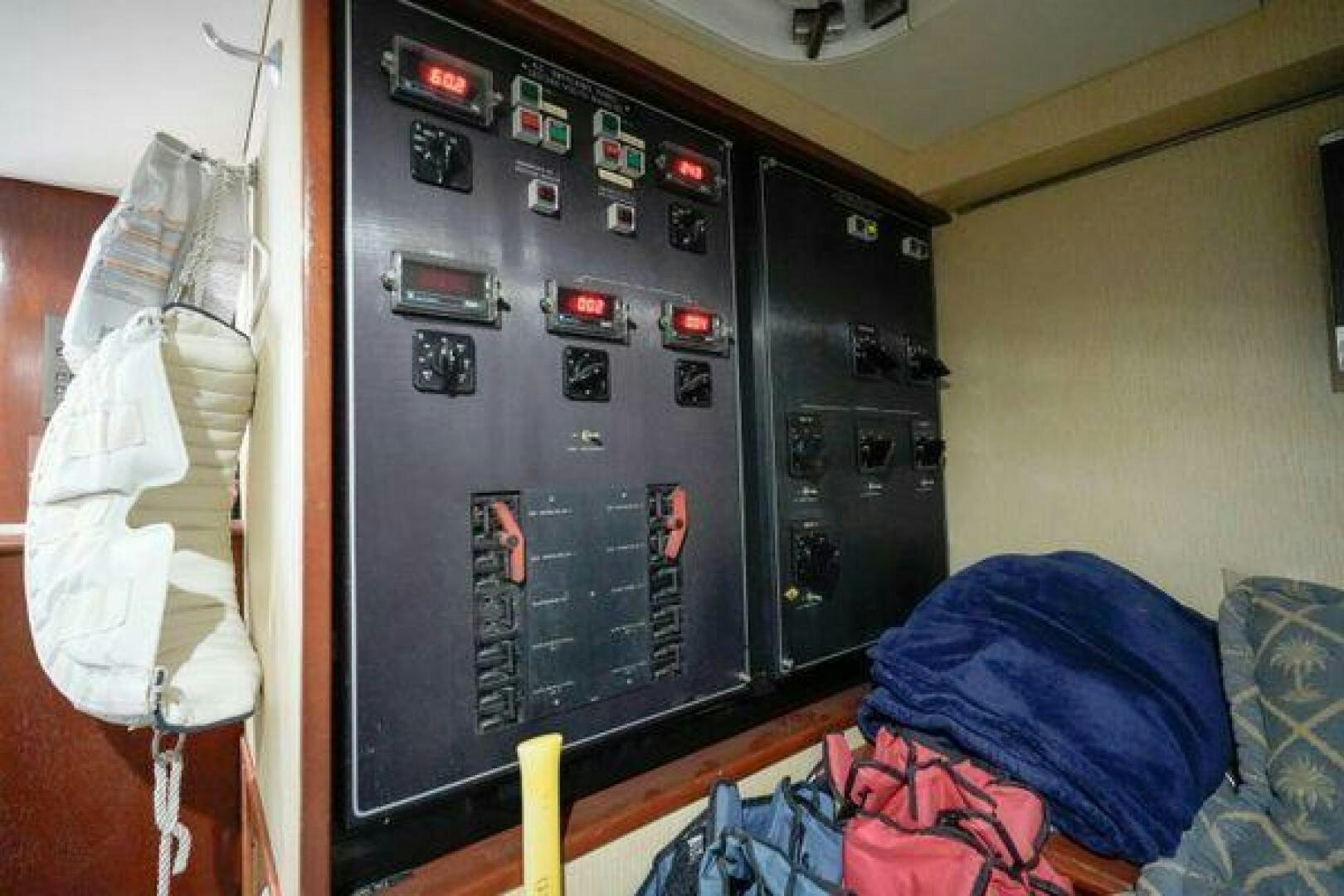 a black board with buttons and a white wall aboard POLE POSITION Yacht for Sale