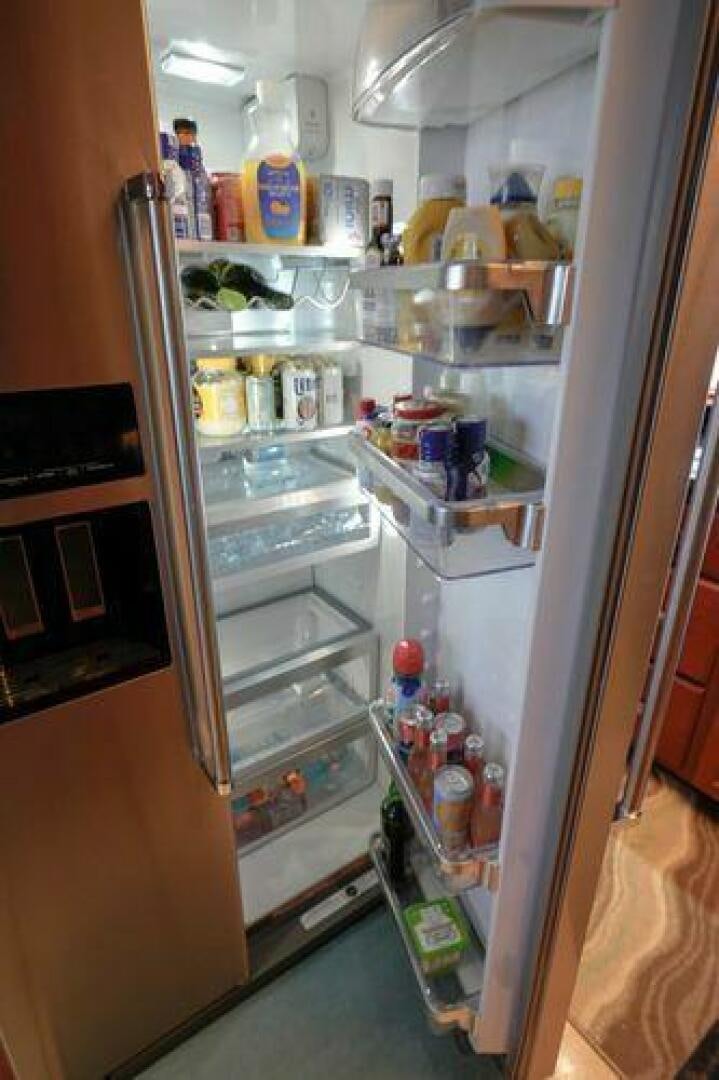 a refrigerator is filled with food aboard POLE POSITION Yacht for Sale