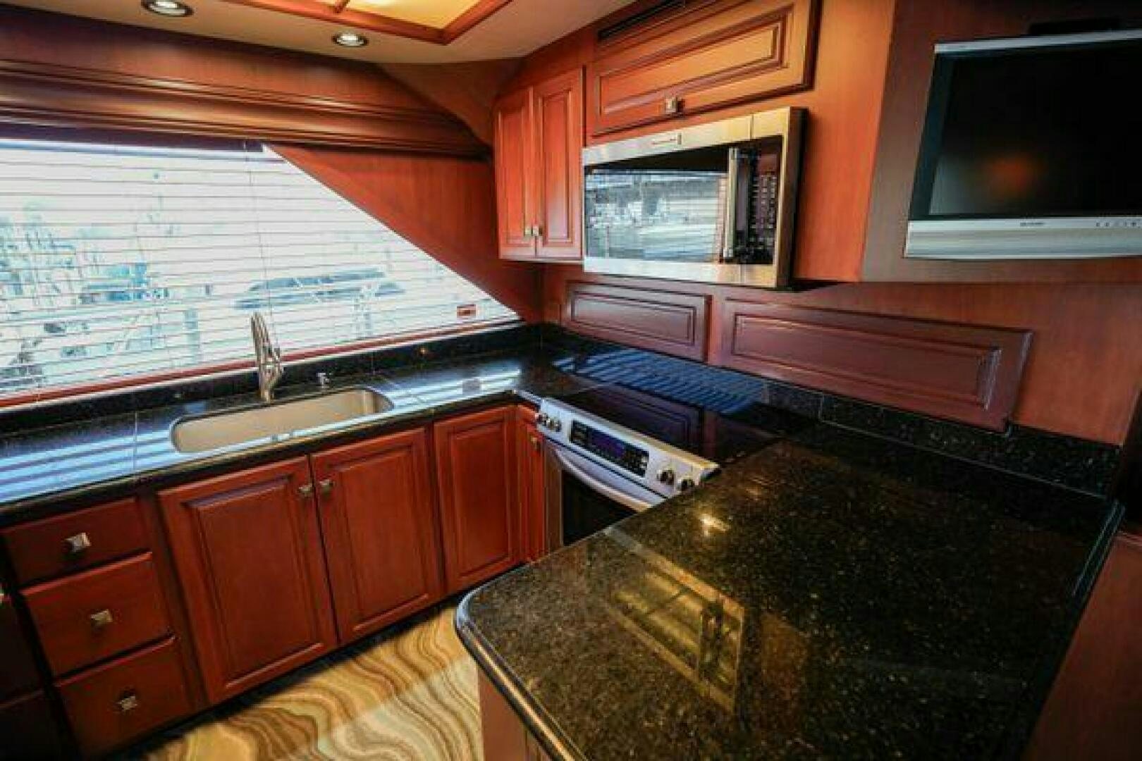 a kitchen with wooden cabinets aboard POLE POSITION Yacht for Sale