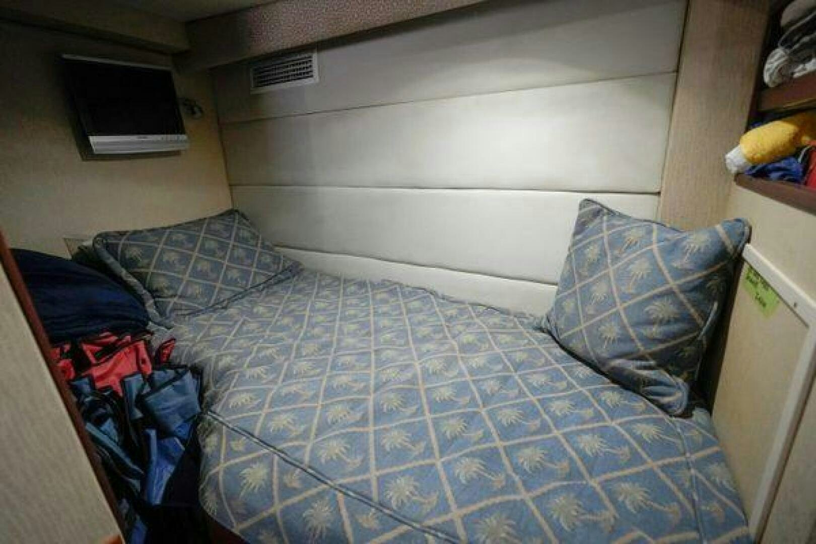 a bed with blue sheets aboard POLE POSITION Yacht for Sale
