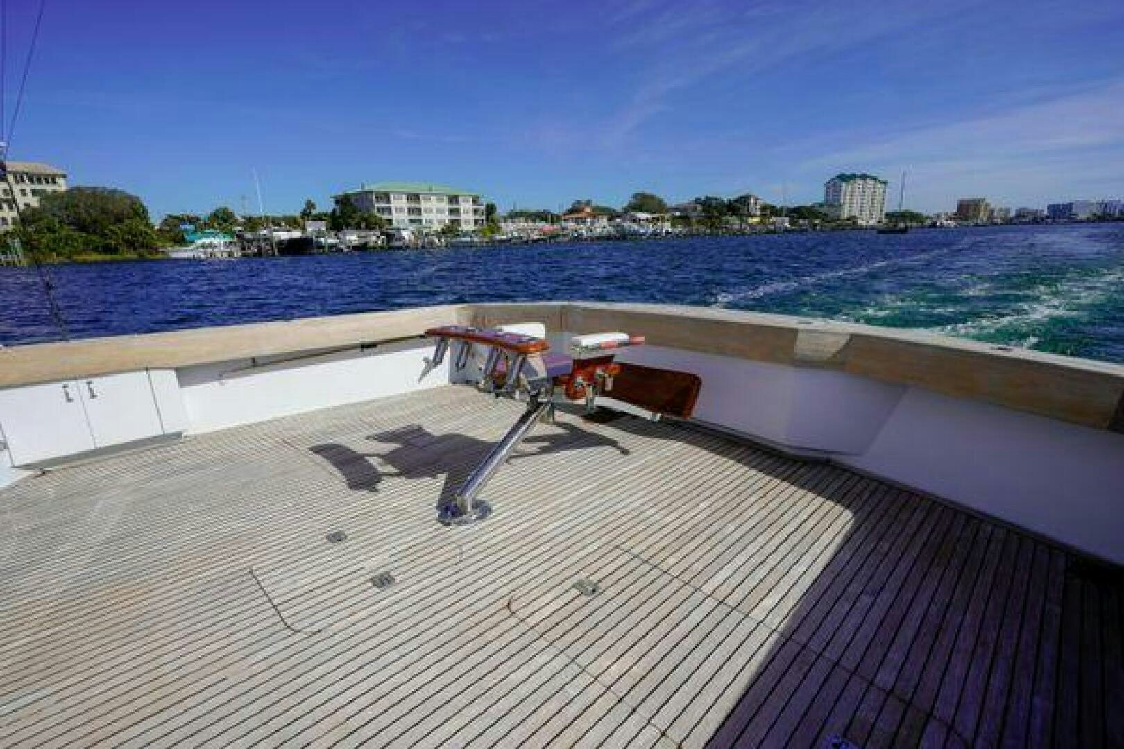 a deck with a chair on it by the water aboard POLE POSITION Yacht for Sale