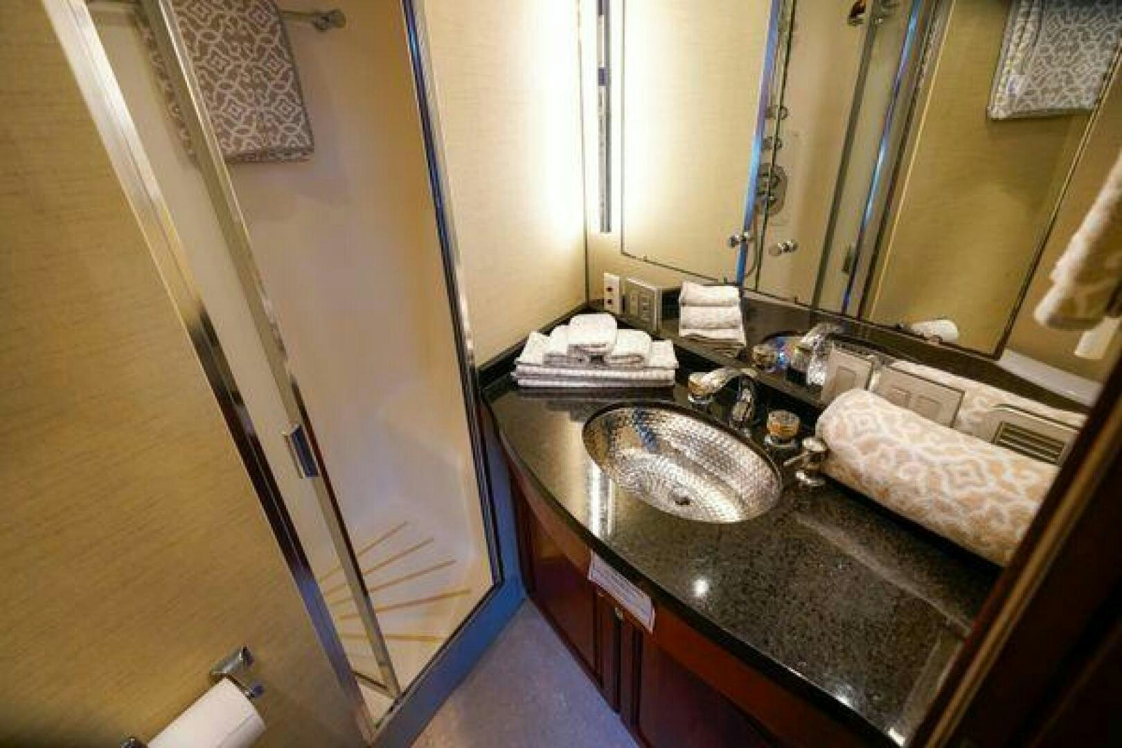 a bathroom with a sink and a mirror aboard POLE POSITION Yacht for Sale