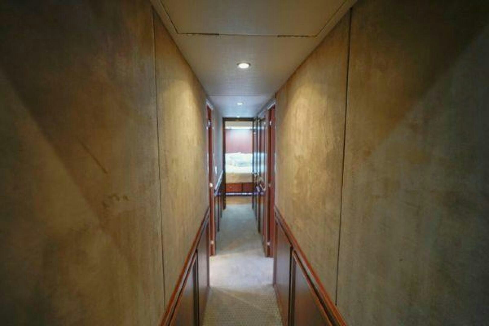 a hallway with a door and a hallway with doors aboard POLE POSITION Yacht for Sale