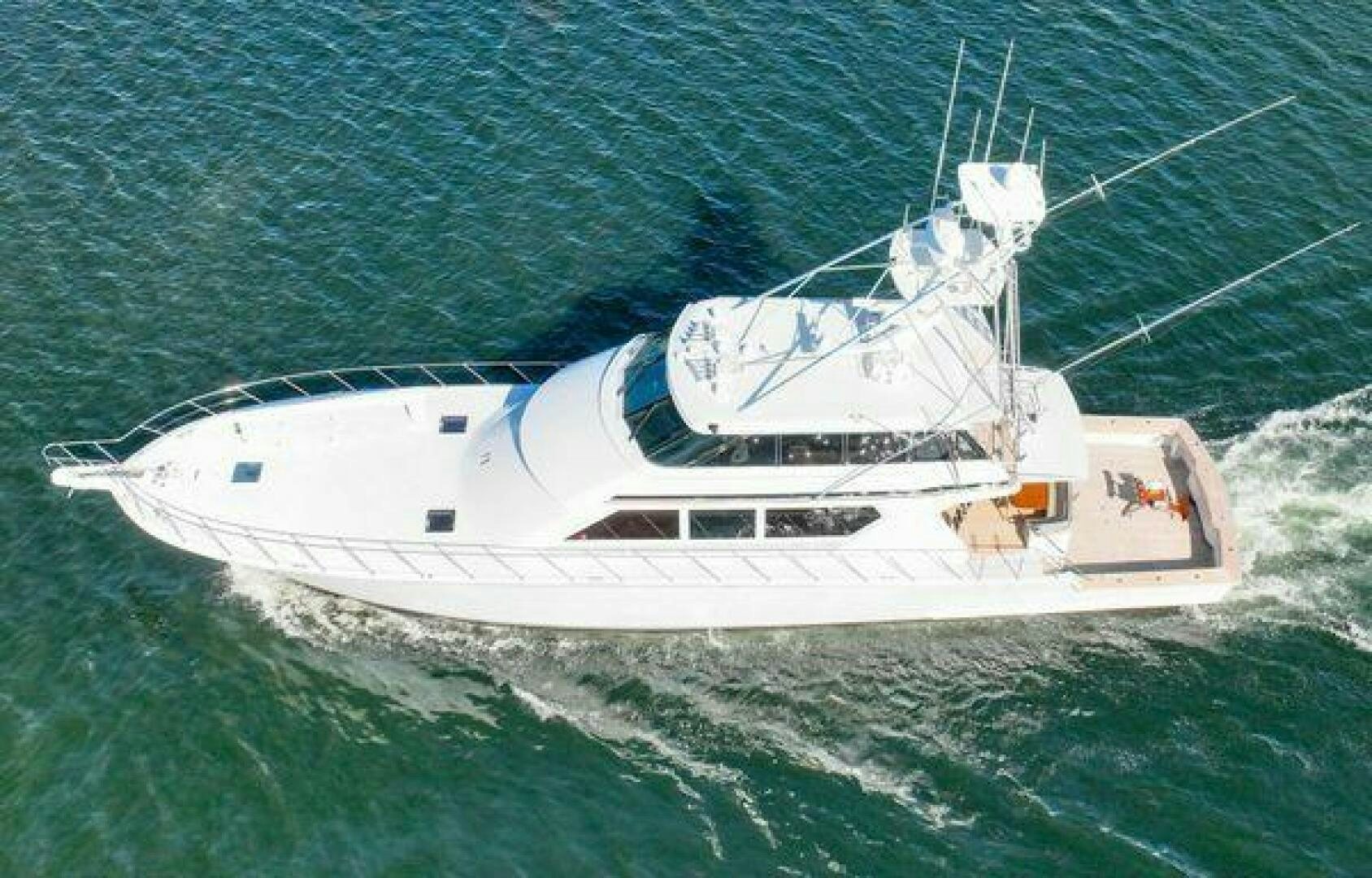 a white yacht in the water aboard POLE POSITION Yacht for Sale