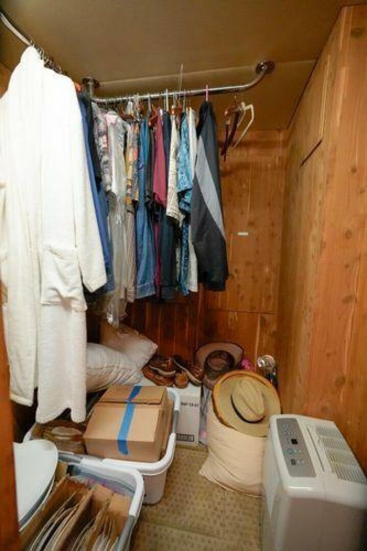 a bathroom with clothes on the wall aboard POLE POSITION Yacht for Sale