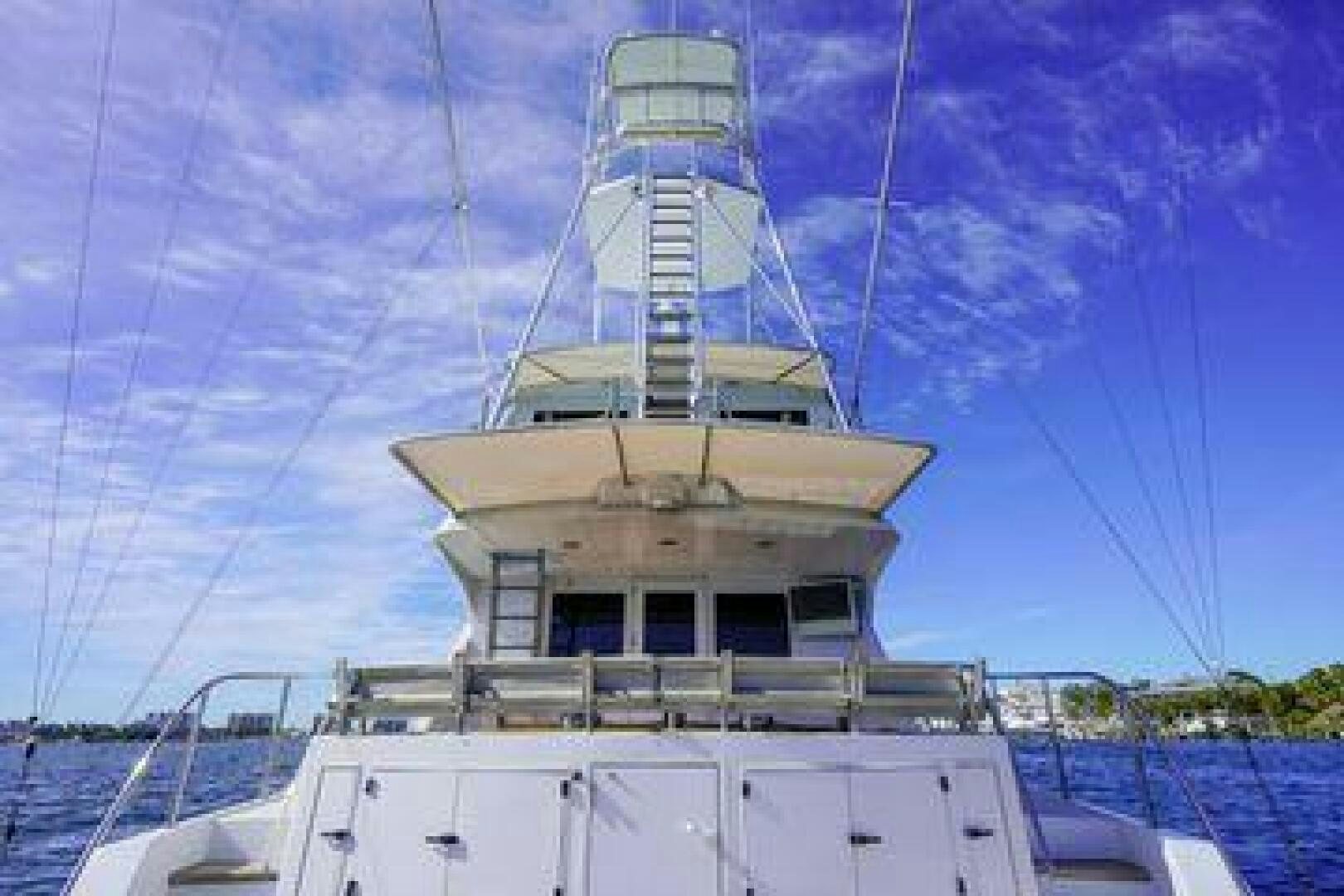 a white boat with a tower aboard POLE POSITION Yacht for Sale
