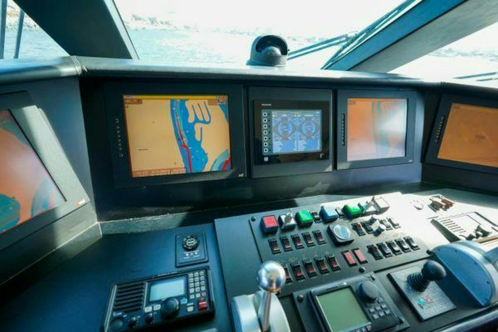 a control panel with multiple monitors aboard POLE POSITION Yacht for Sale