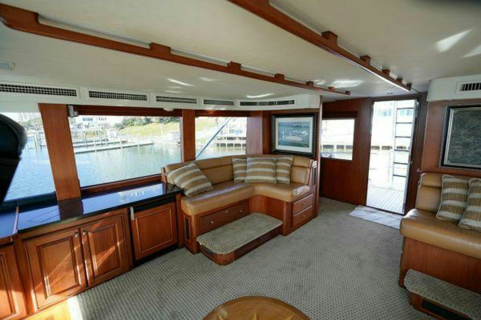a living room with a large window aboard POLE POSITION Yacht for Sale
