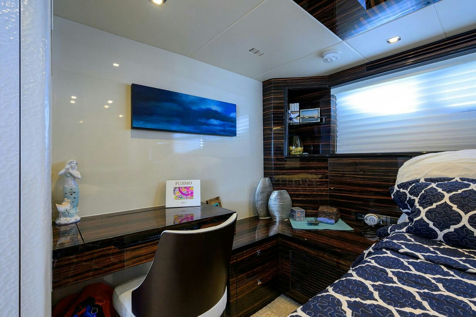 a bedroom with a bed and a desk aboard FUJIMO Yacht for Sale