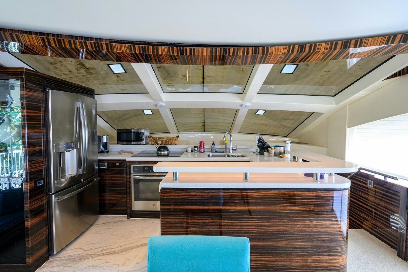a kitchen with a large refrigerator aboard FUJIMO Yacht for Sale