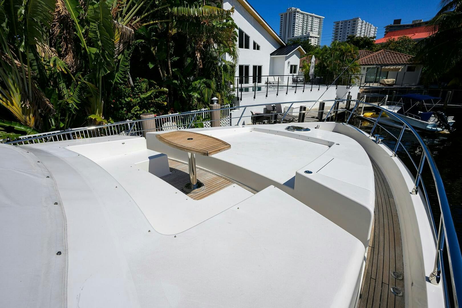 a pool with a white wall and a building in the background aboard FUJIMO Yacht for Sale