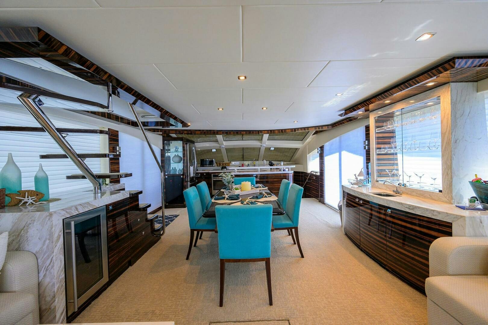 a room with a table and chairs aboard FUJIMO Yacht for Sale