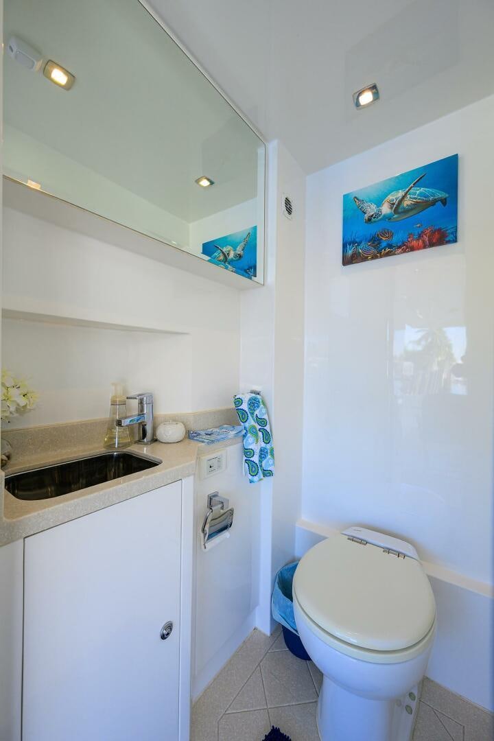 a bathroom with a toilet sink and a mirror aboard FUJIMO Yacht for Sale