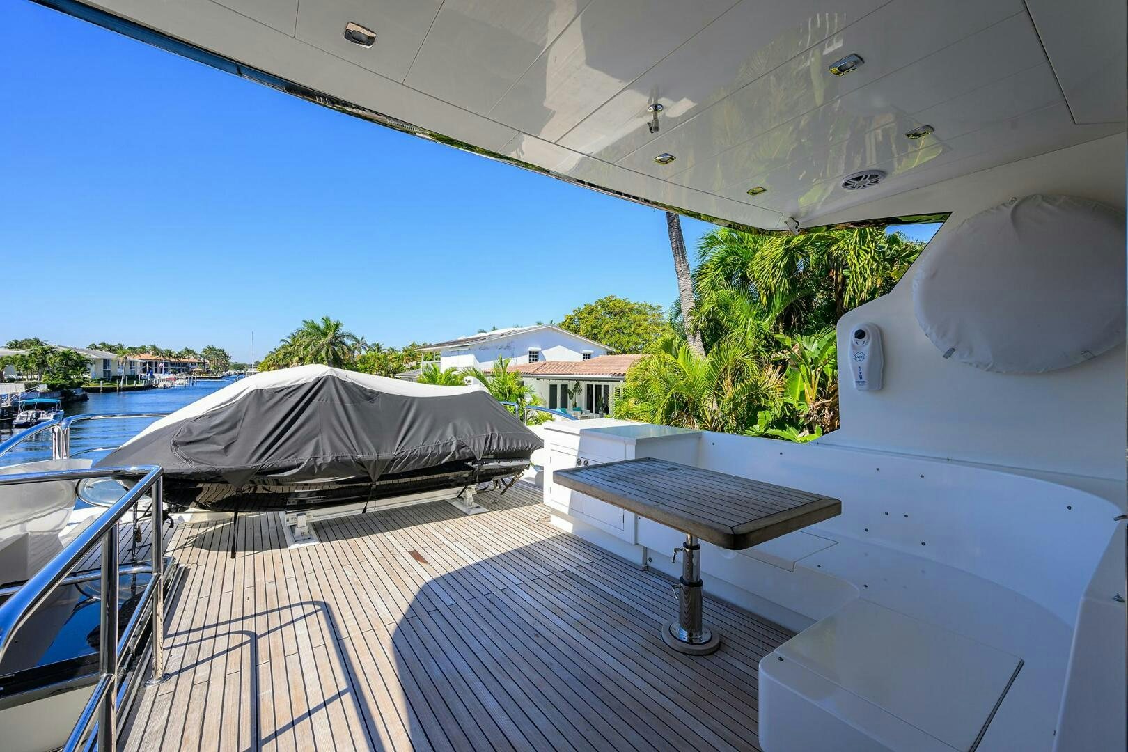 a balcony with a table and a bed on it aboard FUJIMO Yacht for Sale